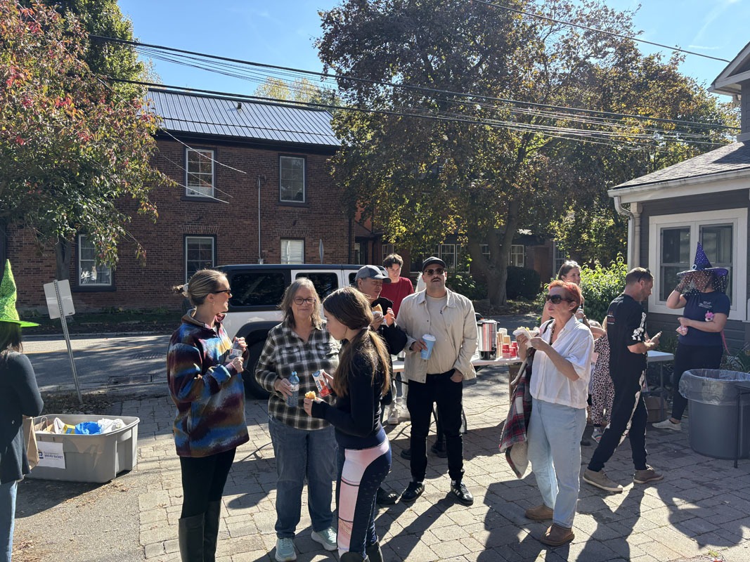 Group photo of the Elaine Jones Group team smiling with clients at Pumpkin Fest in Georgetown.