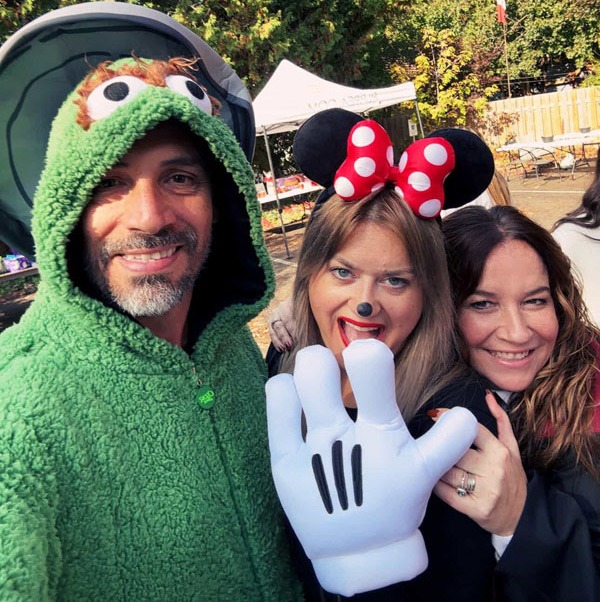Families enjoying Pumpkin Fest activities, dressed up in costumes